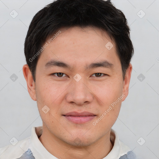 Joyful asian young-adult male with short  brown hair and brown eyes