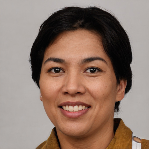 Joyful asian adult female with short  brown hair and brown eyes