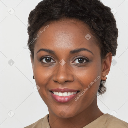 Joyful black young-adult female with short  brown hair and brown eyes