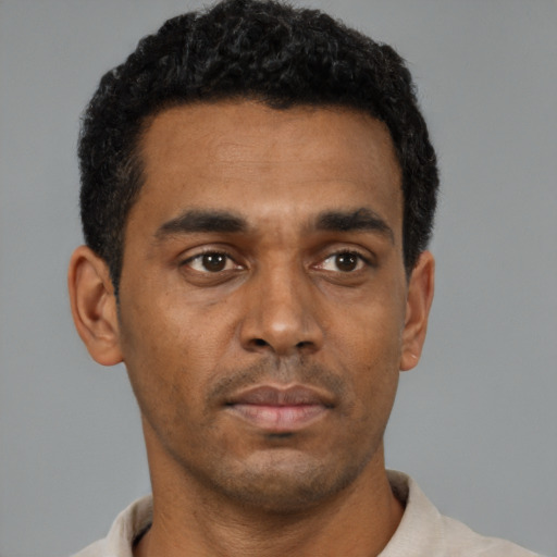 Neutral black young-adult male with short  black hair and brown eyes