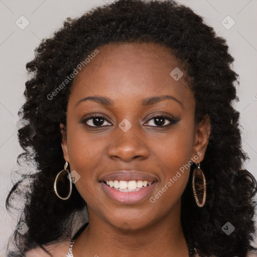 Joyful black young-adult female with long  black hair and brown eyes