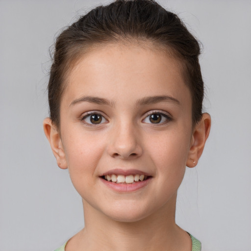 Joyful white child female with short  brown hair and brown eyes