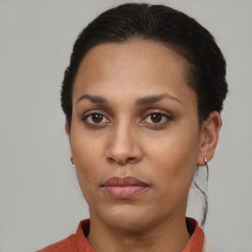 Joyful black young-adult female with short  brown hair and brown eyes