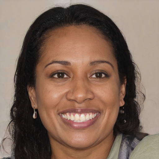 Joyful black adult female with medium  brown hair and brown eyes