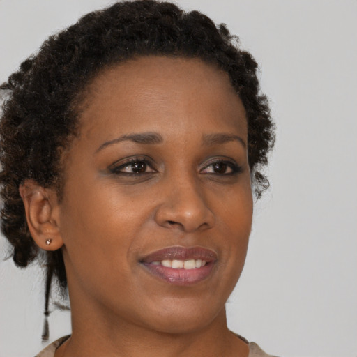 Joyful black young-adult female with short  brown hair and brown eyes