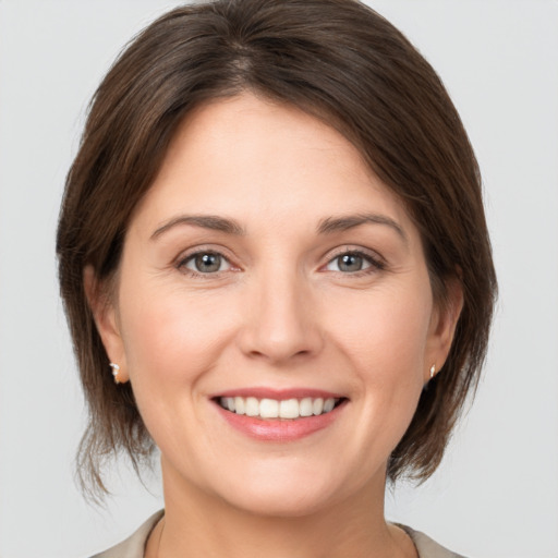 Joyful white young-adult female with medium  brown hair and brown eyes