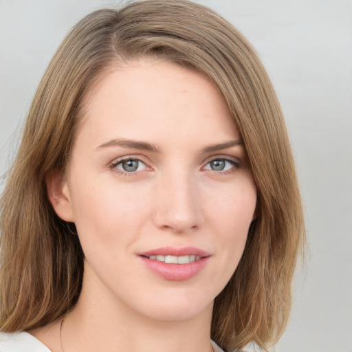 Joyful white young-adult female with medium  brown hair and blue eyes