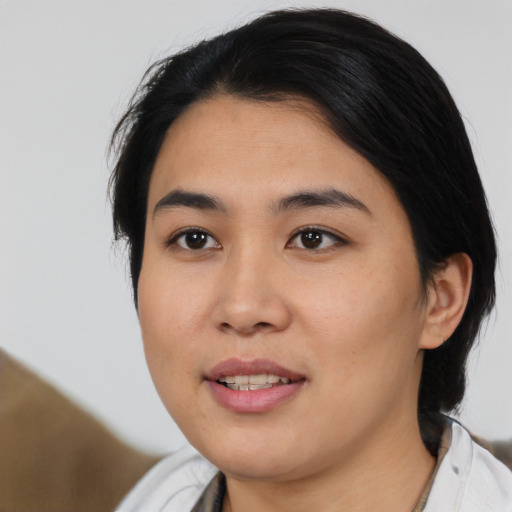 Joyful asian young-adult female with medium  black hair and brown eyes