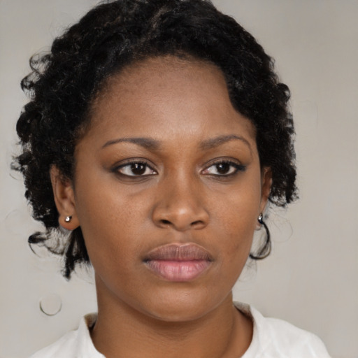 Neutral black young-adult female with medium  brown hair and brown eyes