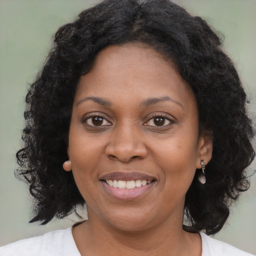 Joyful black young-adult female with medium  brown hair and brown eyes