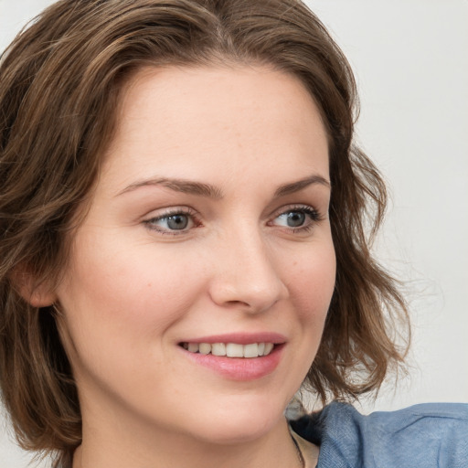 Joyful white young-adult female with medium  brown hair and blue eyes