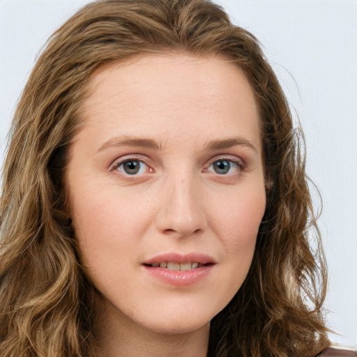 Joyful white young-adult female with long  brown hair and green eyes