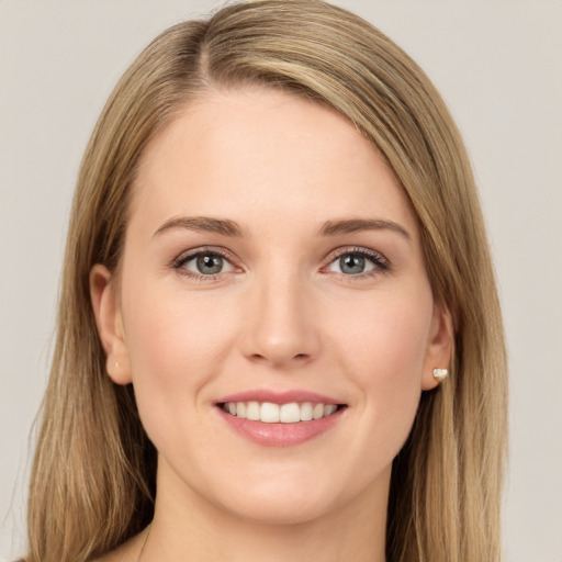 Joyful white young-adult female with long  brown hair and green eyes