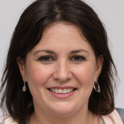 Joyful white adult female with medium  brown hair and grey eyes