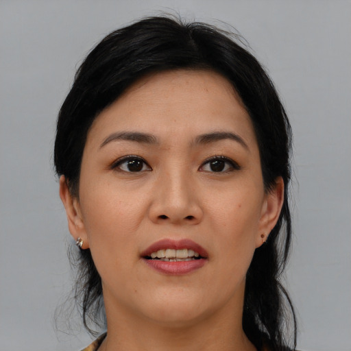 Joyful asian young-adult female with medium  black hair and brown eyes