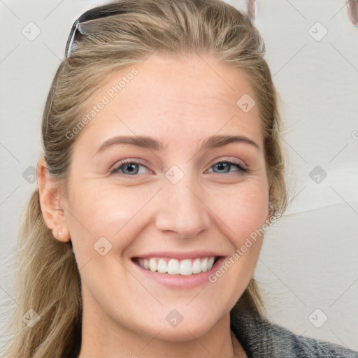 Joyful white young-adult female with long  brown hair and blue eyes