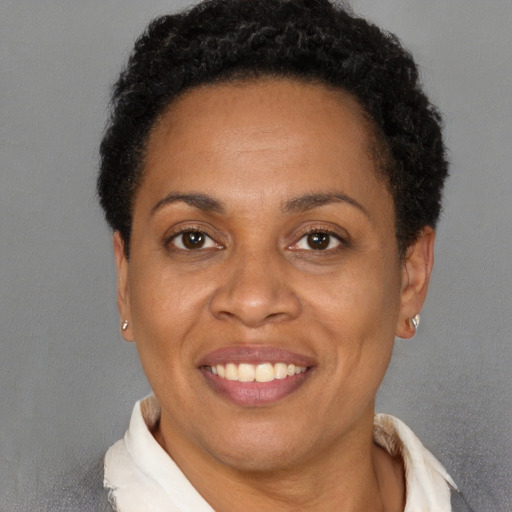Joyful latino adult female with short  brown hair and brown eyes