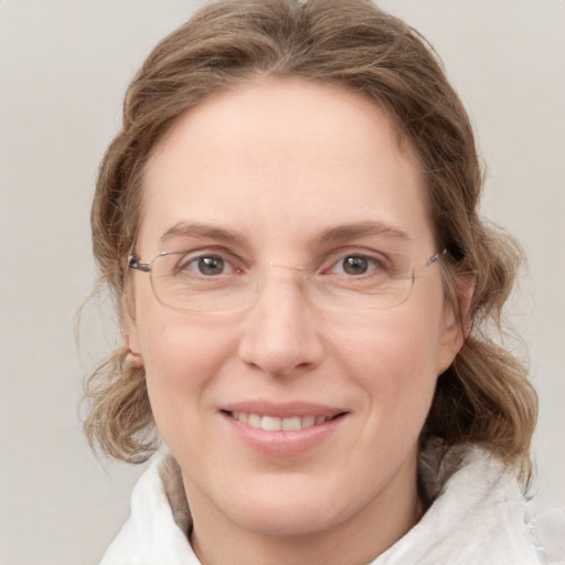 Joyful white adult female with medium  brown hair and blue eyes