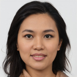 Joyful asian young-adult female with medium  brown hair and brown eyes