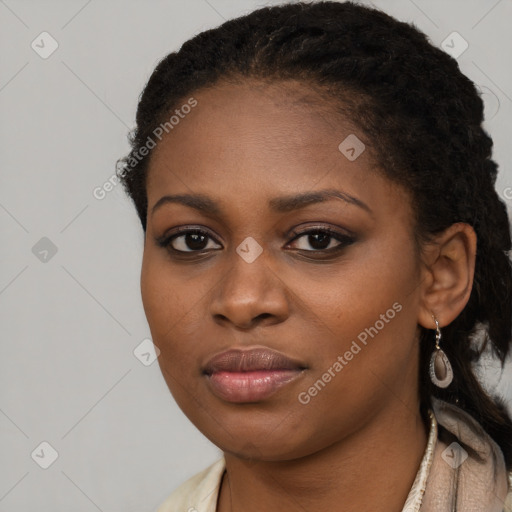 Joyful black young-adult female with long  black hair and brown eyes