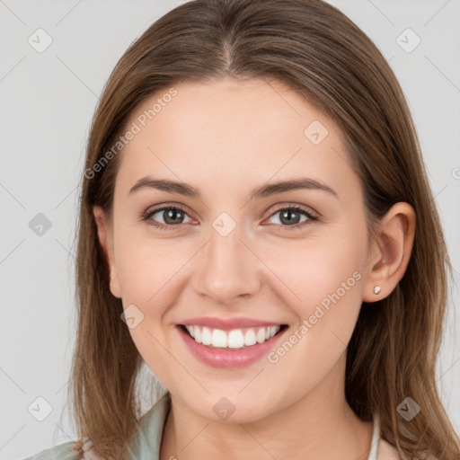 Joyful white young-adult female with long  brown hair and grey eyes