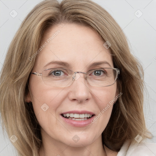 Joyful white adult female with long  brown hair and blue eyes