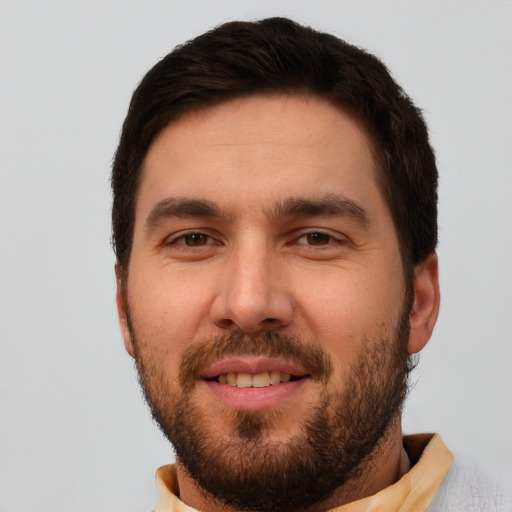 Joyful white young-adult male with short  brown hair and brown eyes