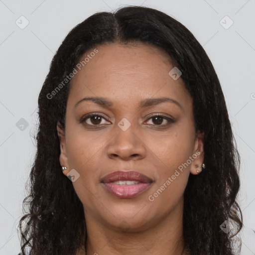 Joyful black young-adult female with long  brown hair and brown eyes