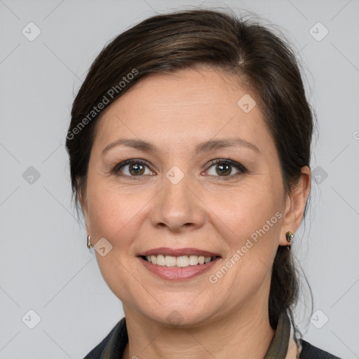 Joyful white adult female with medium  brown hair and brown eyes