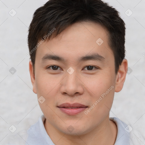Joyful asian young-adult male with short  brown hair and brown eyes