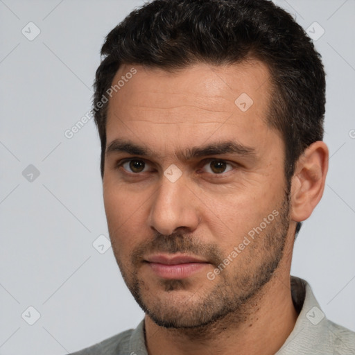 Joyful white adult male with short  brown hair and brown eyes