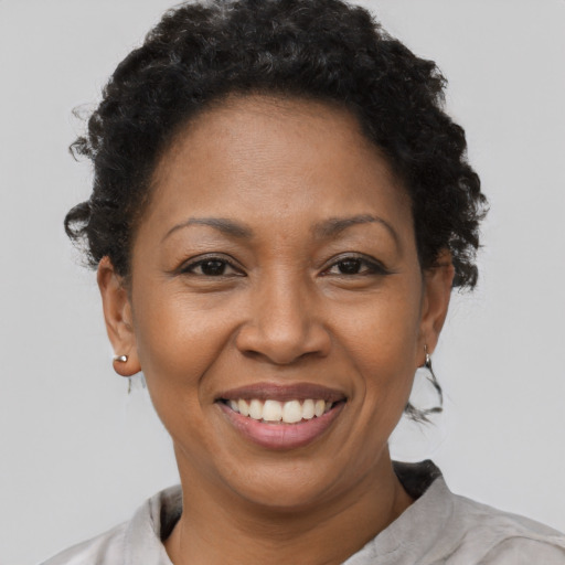 Joyful black adult female with short  brown hair and brown eyes