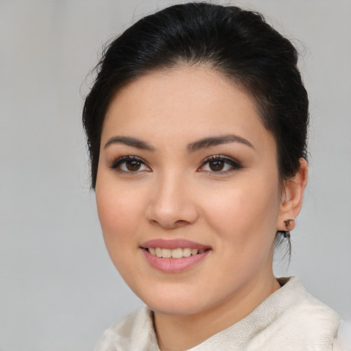 Joyful asian young-adult female with medium  brown hair and brown eyes