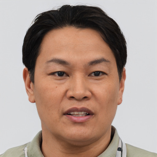 Joyful asian adult male with short  black hair and brown eyes