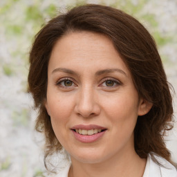 Joyful white adult female with medium  brown hair and brown eyes