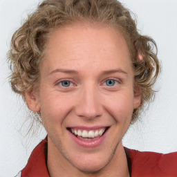 Joyful white young-adult female with medium  brown hair and blue eyes