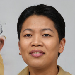 Joyful asian young-adult female with short  black hair and brown eyes