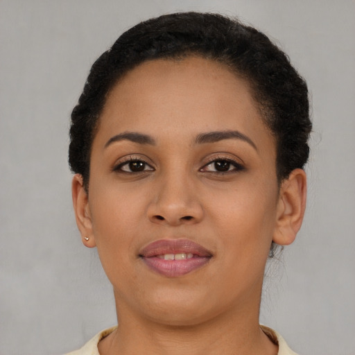Joyful latino young-adult female with short  brown hair and brown eyes