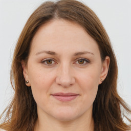 Joyful white adult female with long  brown hair and brown eyes