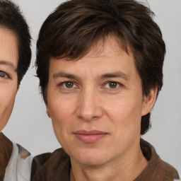 Joyful white adult male with medium  brown hair and brown eyes