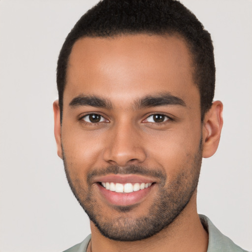 Joyful latino young-adult male with short  brown hair and brown eyes