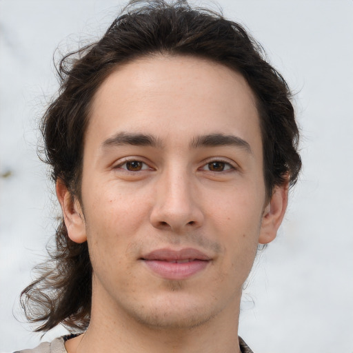 Joyful white young-adult male with medium  brown hair and brown eyes