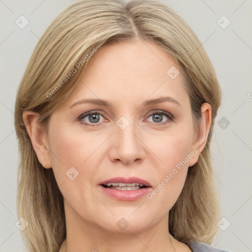 Joyful white adult female with medium  brown hair and blue eyes