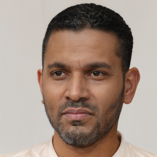 Neutral latino adult male with short  black hair and brown eyes
