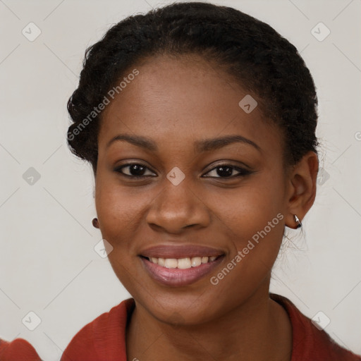 Joyful black young-adult female with long  brown hair and brown eyes