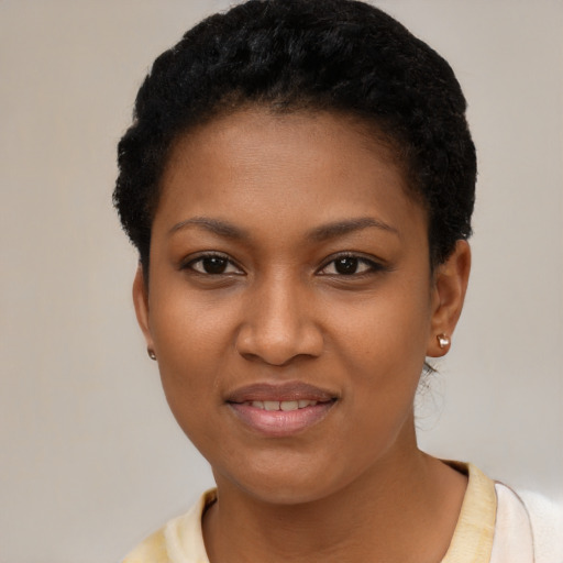 Joyful black young-adult female with short  black hair and brown eyes
