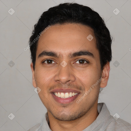 Joyful latino young-adult male with short  black hair and brown eyes