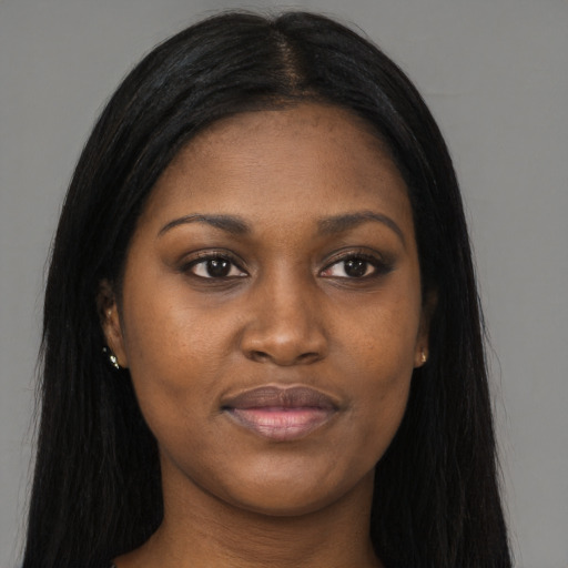 Joyful black young-adult female with long  black hair and brown eyes