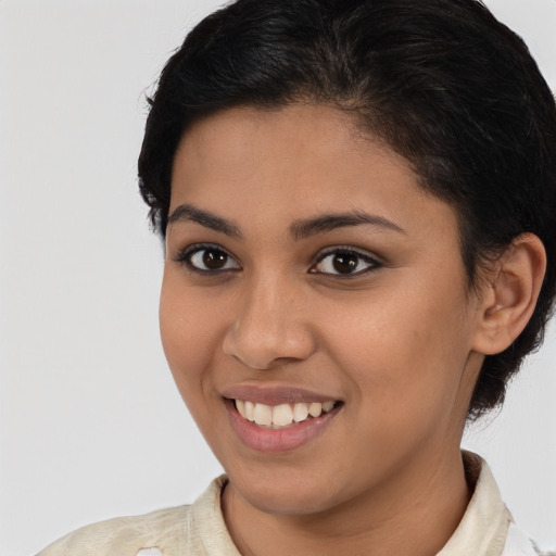 Joyful latino young-adult female with short  brown hair and brown eyes