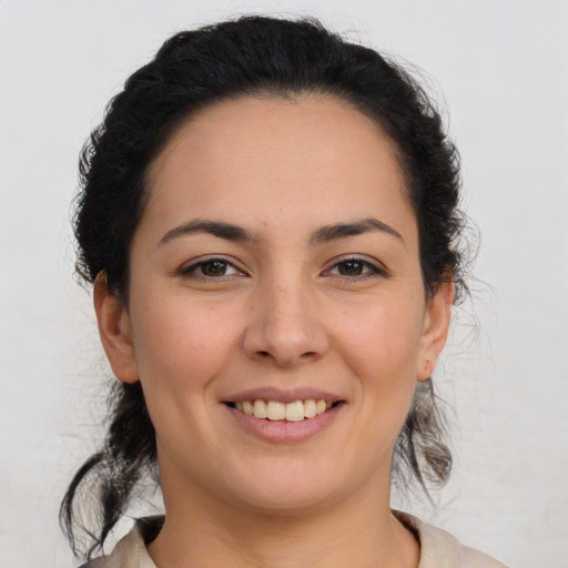 Joyful latino young-adult female with medium  brown hair and brown eyes